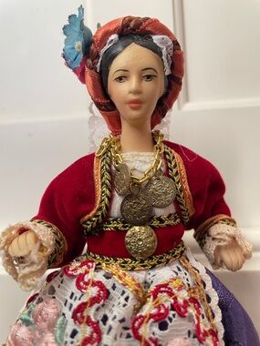 Vintage Red-Trimmed Traditional Doll with Coin Necklace